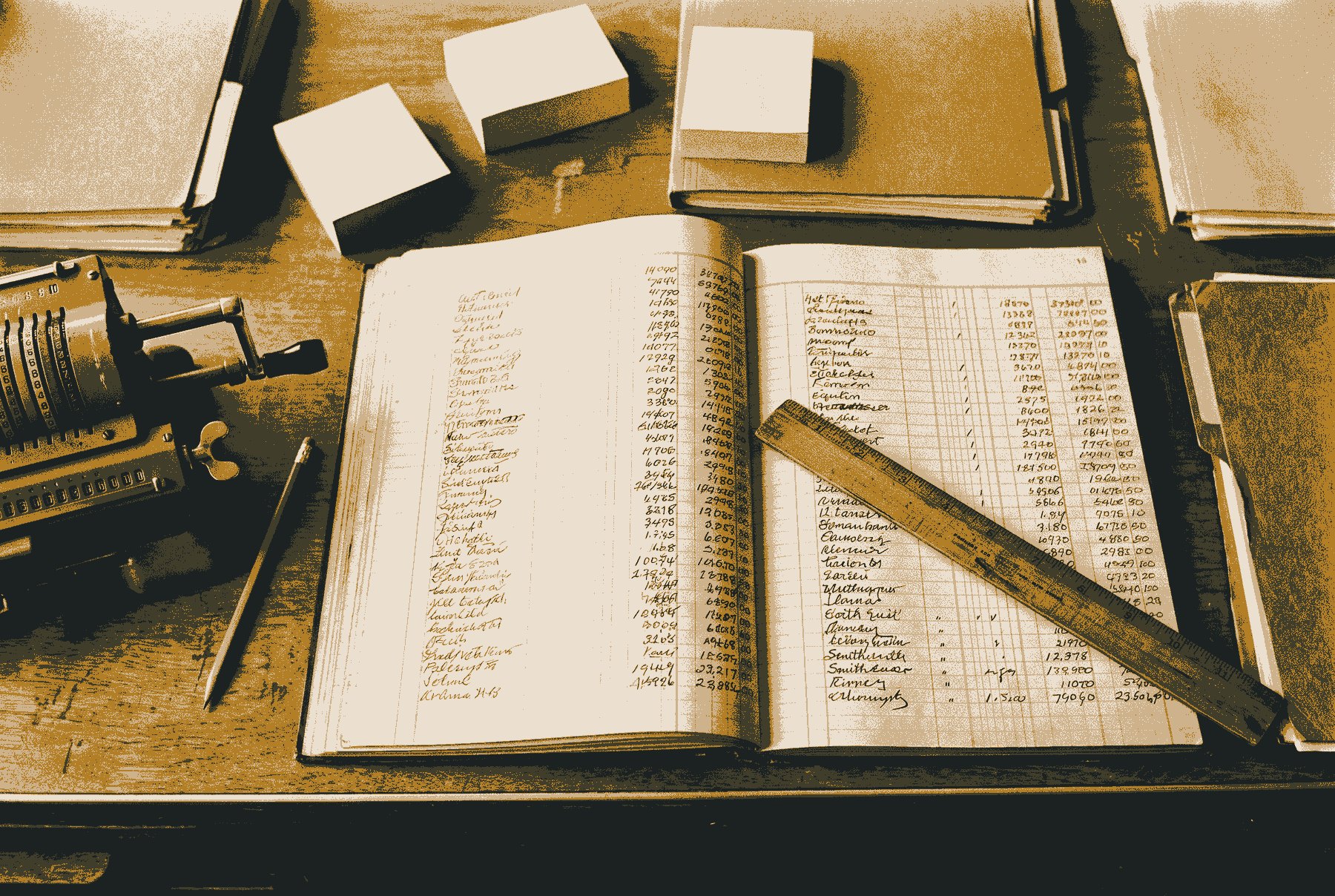 An open cost ledger seen from above, its columns filled with illegible handwritten marks, with a mechanical adding machine, a pencil and a ruler laid across the page.